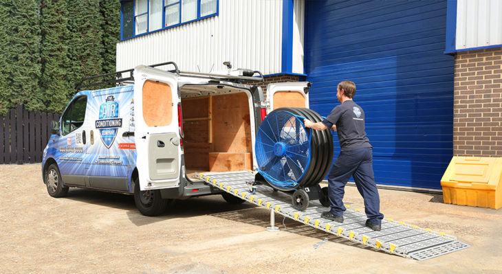 Man on Roll-a-Ramp attached to van